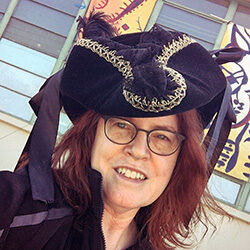 Artist Melani Grube in a Pirate hat delivering her painting, "Skelly Pirates" to the Sacramento Fine Arts Center for the Magnum Opus Show 2021, Carmichael, California.